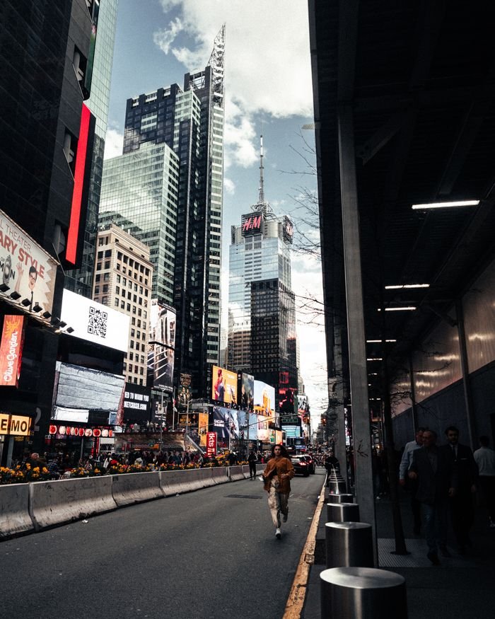 Home Bustling Times Square with skyscrapers and digital billboards in New York City.